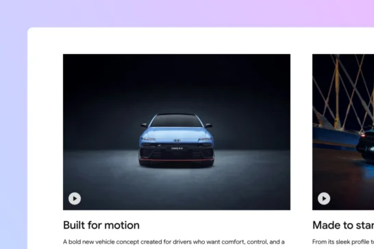 A car website displaying two videos with a clean, minimal play button.